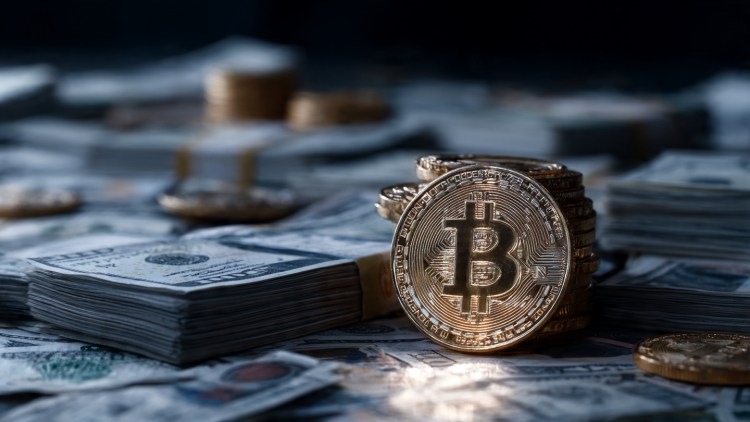 bitcoin-physical-coin-and-stacks-of-us-dollar-bill.jpeg